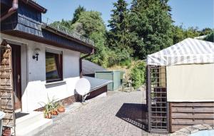 a garden with a brick walkway next to a house at 2 Bedroom Nice Home In Sellerich in Sellerich