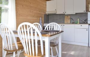 a kitchen with a table with four chairs around it at Gorgeous Home In Vallavik With Wifi in Vangsbygd +6 photos