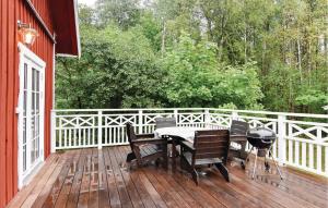 une terrasse en bois avec un grill, une table et des chaises dans l'établissement Lovely Home In lgars With Kitchen, à Älgarås