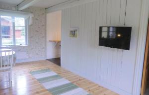 a living room with a television on a wall at Stunning Home In Borgholm With Kitchen in Borgholm