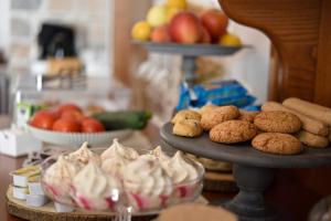 a table topped with plates of desserts and fruit at Hotel Goloritzé in Baunei
