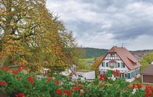 uma vista de uma casa com flores no primeiro plano em Amazing Home In Alpirsbach-rmlinsdorf With 2 Bedrooms em Marschalkenzimmern
