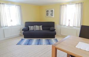 a living room with a couch and a table at Holiday Home Spånghult Älmhult Ii in Liatorp