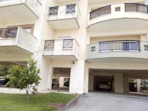 an apartment building with balconies and a parking lot at Vanessa's studio in Agia Triada