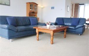 a living room with two blue couches and a coffee table at 1 Bedroom Amazing Apartment In Breskens in Breskens