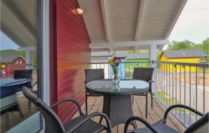 a patio with a table and chairs on a balcony at Ferienhausdorf Thale in Thale