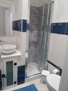 a bathroom with a shower and a toilet and a sink at the smerald 2.2 in Alghero