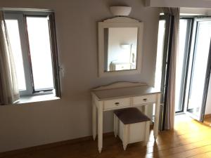 a bathroom with a white dressing table and a mirror at Loukia in Kondiás