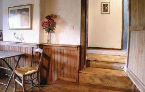 a room with a table and a vase of flowers at Holiday Home Le Coussot in Beaulieu-sur-Sonnette