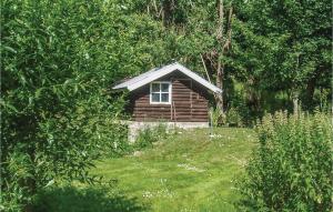 a small log cabin in the middle of a yard at 3 Bedroom Gorgeous Home In Tomelilla in Tomelilla