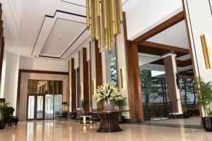 a lobby with a vase of flowers on a table at Mason Pine Hotel Bandung in Padalarang