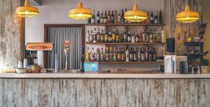 a bar with bottles of alcohol on the shelves at Comitas Tramontana Park in Fornells