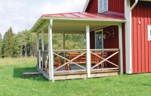 a front porch of a red house with a deck at Amazing Home In Blidsberg With 2 Bedrooms And Wifi in Blidsberg