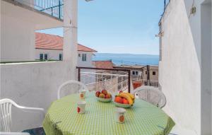a table with two bowls of fruit on a balcony at Pet Friendly Apartment In Jesenice Bajnice With Kitchen in Jesenice