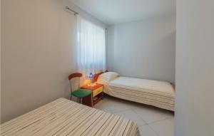 Zimmer mit 2 Betten, einem Tisch und einem Stuhl in der Unterkunft 1 Bedroom Stunning Apartment In Opatija in Opatija