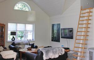 sala de estar con 2 sillas, mesa y escalera en Lovely Home In Lttorp With Wifi, en Norrböda
