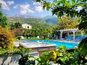 a swimming pool with mountains in the background at Apartmani Novaković in Kotor