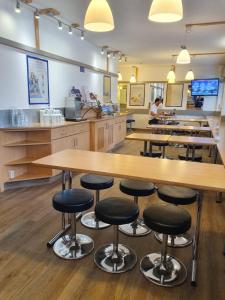 
a kitchen filled with wooden tables and chairs at ibis budget Erfurt Ost in Erfurt

