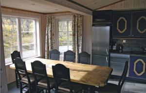 a dining room with a wooden table and chairs at Stunning Home In Hemsedal With 4 Bedrooms, Sauna And Wifi in Hemsedal