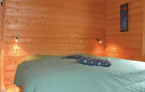 a bedroom with a bed in a wooden wall at Two-Bedroom Holiday Home In Sorvagen in Sørvågen