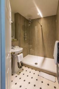 a bathroom with a shower and a tub and a sink at West Dean College in West Dean