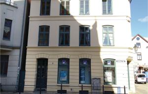 a white building with blue doors and windows at 2 Bedroom Awesome Apartment In Wismar in Wismar