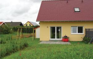 a small yellow house with a red roof at Holiday Apartment Boiensdorf 03 in Boiensdorf