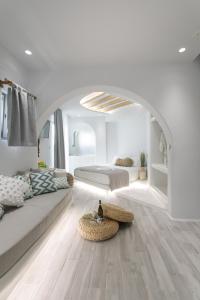 a white living room with a couch and a table at Majestique of Naxos in Naxos Chora