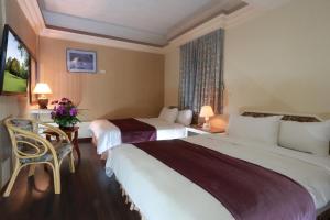 Postel nebo postele na pokoji v ubytování King Town Hotel
