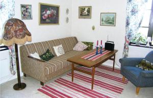 a living room with a couch and a table at Holiday Home Ljungkullen Ramkvilla in Ramkvilla