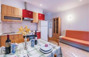 a kitchen and dining room with a table and a couch at Nice Apartment In Fazana With Wifi in Fondole