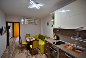 a kitchen and living room with a couch and a table at Madini apartment in Velingrad
