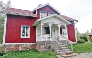 a red and white house with stairs in front of it at 3 Bedroom Nice Home In Mariannelund in Svenstorp