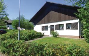 a white house with a black roof at Ferienhaus 13 In Thalfang in Thalfang