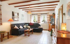 a living room with a couch and a table at Ferienhaus 13 In Thalfang in Thalfang