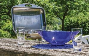 a blue bowl sitting on a table with two glasses at Ferienhaus 4 In Thalfang in Thalfang +24 photos