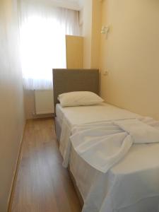 A bed or beds in a room at Hagia Sophia Apartment