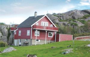 a red house sitting on top of a hill at Nice Home In Sirevåg With Kitchen in Sirevåg