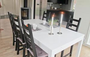 a white dining room table with two candles on it at Lovely Home In Hamburgsund With Wifi in Hamburgsund