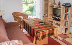 a living room with a table and a tv at Beautiful Home In Usedom With Kitchen in Wilhelmshof