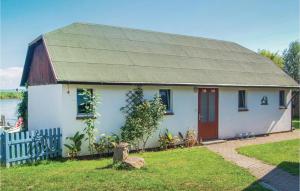 a white house with a red door and a fence at Beautiful Home In Usedom With Kitchen in Wilhelmshof