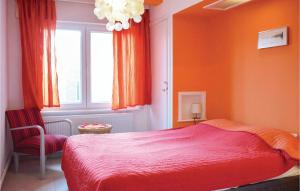 a bedroom with a red bed and a window at Residentie Emeraude 4D in Ostend