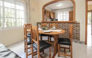 a dining room with a table and chairs and a mirror at Villa Maria in Coín