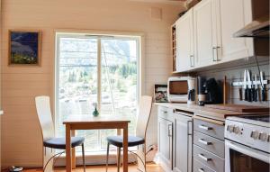 a kitchen with a table and chairs and a window at Gorgeous Home In Eivindvik With Kitchen in Eivindvik