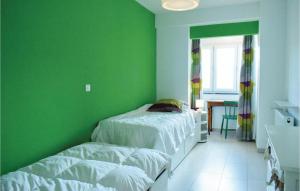 a green bedroom with two beds and a window at Residentie Emeraude 4D in Ostend +5 photos
