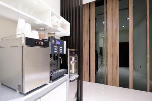 Yu Chun Hotel في تايتشونغ: مطبخ مع ماكينة قهوة على كونتر