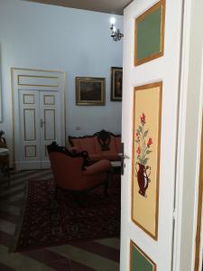 a door leading into a living room with a couch at B&B Palazzo Antonelli in Monopoli