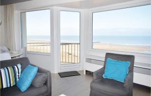 a living room with two chairs and a view of the beach at Residentie Emeraude 4D in Ostend
