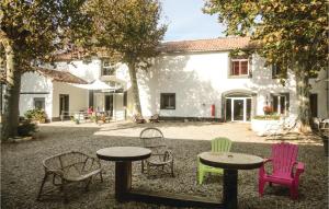 a group of chairs and tables in front of a building at Nice Home In Narbonne With Sauna in Narbonne