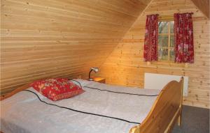 a bedroom with a bed in a log cabin at Three-Bedroom Holiday Home In Ystad in Ystad